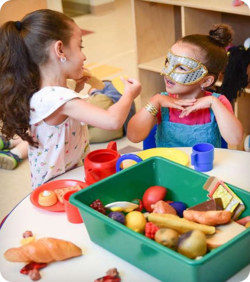 Children playing together at a classroom table